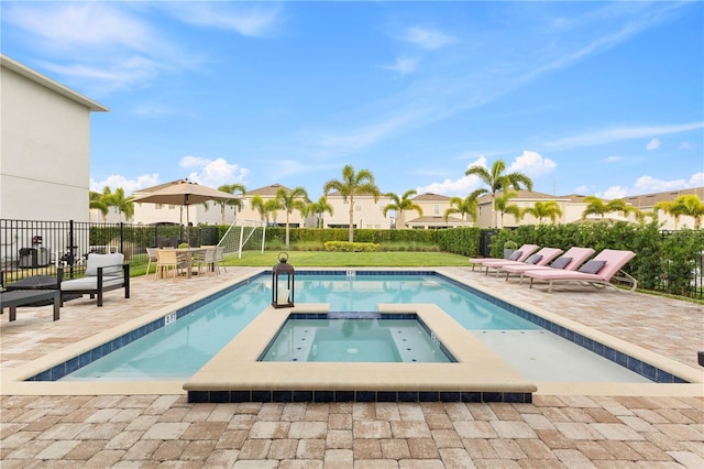 257 Auburn Ave, Kissimmee, FL 34747 - view of swimming pool with a patio, fence, a pool with connected hot tub, and a residential view