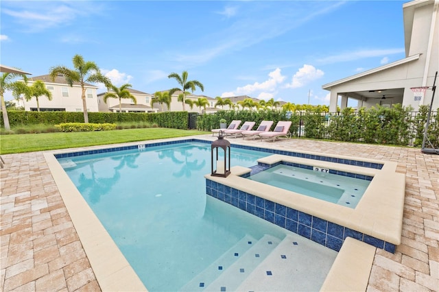 257 Auburn Ave, Kissimmee, FL 34747 - view of swimming pool with a patio, a pool with connected hot tub, a ceiling fan, and a residential view