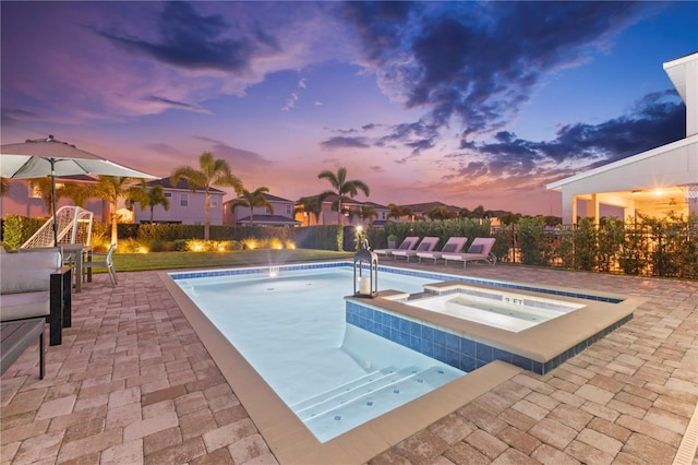 257 Auburn Ave, Kissimmee, FL 34747 - pool at dusk with an in-ground hot tub and a patio area