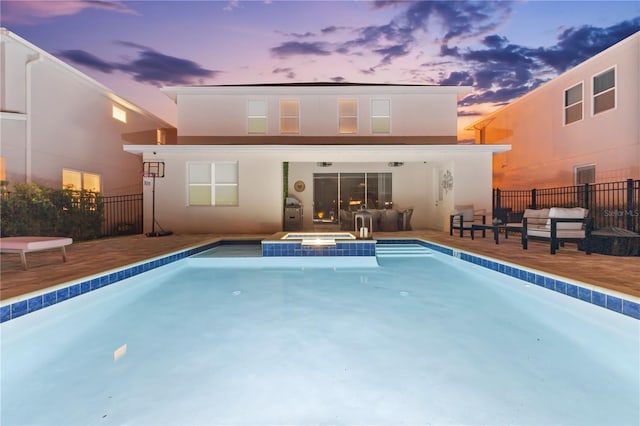 257 Auburn Ave, Kissimmee, FL 34747 - back of house featuring fence, a pool with connected hot tub, a patio, and stucco siding