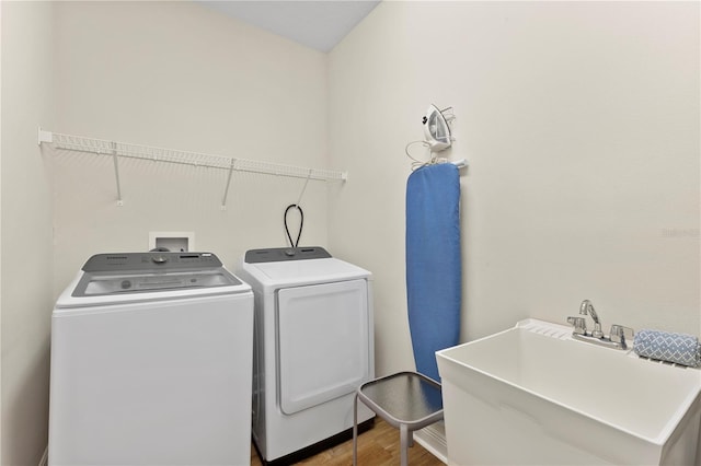 257 Auburn Ave, Kissimmee, FL 34747 - washroom featuring washing machine and clothes dryer and wood finished floors