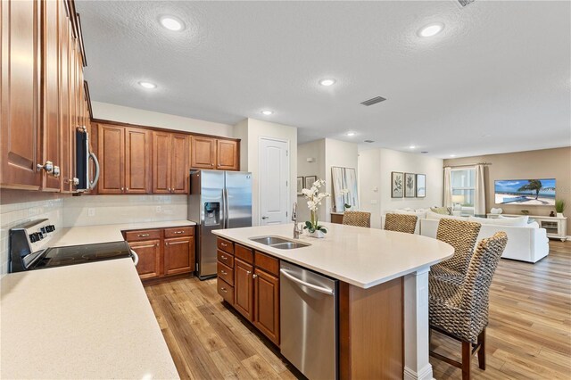 257 Auburn Ave, Kissimmee, FL 34747 - kitchen with appliances with stainless steel finishes, a sink, open floor plan, a breakfast bar, and an island with sink