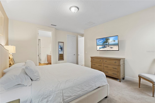 257 Auburn Ave, Kissimmee, FL 34747 - bedroom featuring baseboards, light colored carpet, a textured ceiling, and ensuite bath