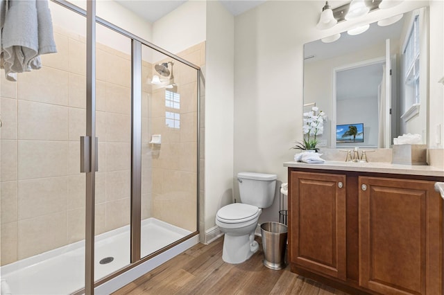 257 Auburn Ave, Kissimmee, FL 34747 - full bathroom with a shower stall, wood finished floors, toilet, and vanity