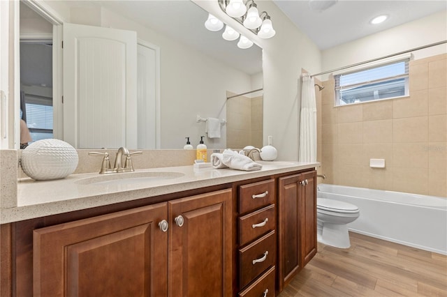257 Auburn Ave, Kissimmee, FL 34747 - full bathroom featuring wood finished floors, shower / bath combo with shower curtain, vanity, and toilet