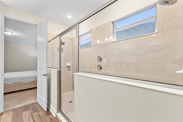 257 Auburn Ave, Kissimmee, FL 34747 - bathroom featuring tiled shower, wood finished floors, and ensuite bath