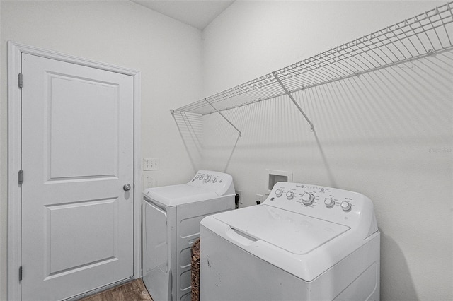 3519 Fernanda Dr, Deltona, FL 32738 - clothes washing area featuring separate washer and dryer and wood finished floors