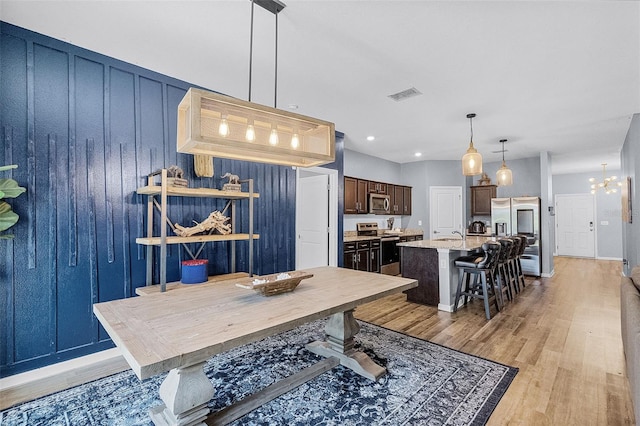 3519 Fernanda Dr, Deltona, FL 32738 - dining space with light wood finished floors and a chandelier