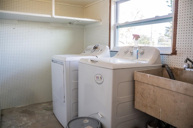 clothes washing area with separate washer and dryer
