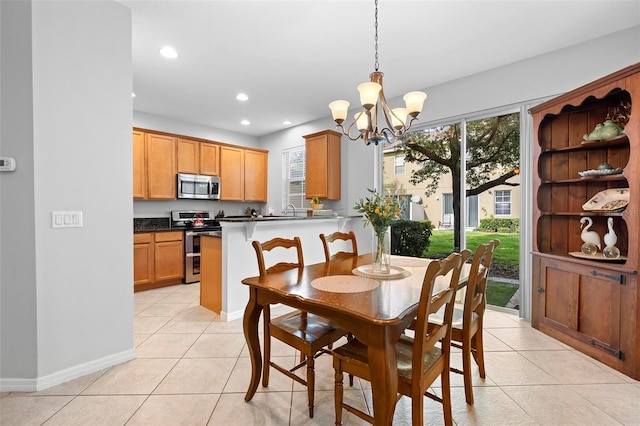 dining space featuring a chandelier, light tile patterned floors, recessed lighting, and baseboards