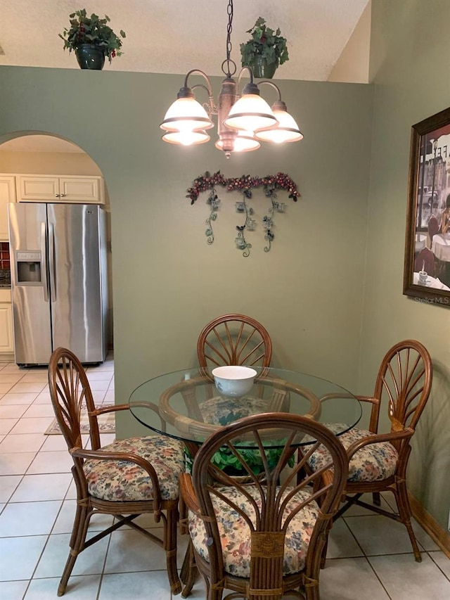 1585 Stefan Cole Ln, Apopka, FL 32703 - dining space with light tile patterned flooring, arched walkways, and a chandelier