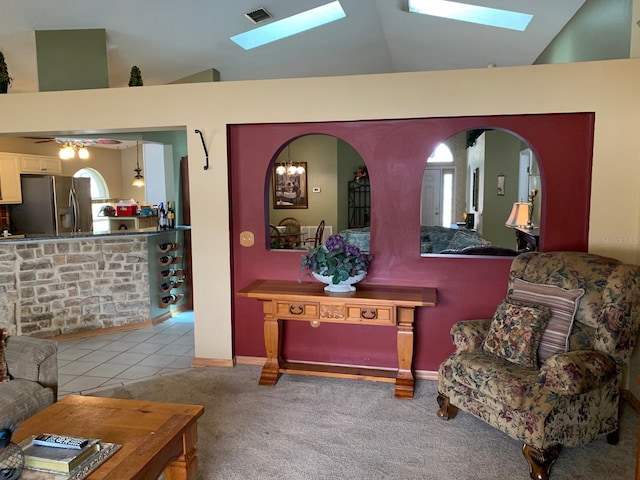 1585 Stefan Cole Ln, Apopka, FL 32703 - living room with a skylight, lofted ceiling, carpet flooring, arched walkways, and a ceiling fan