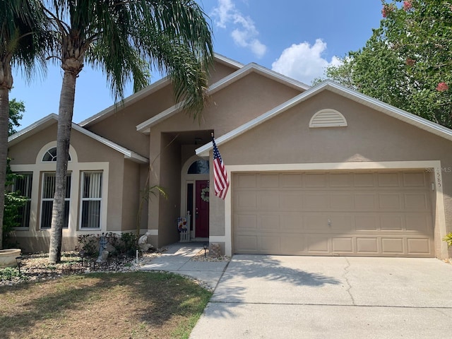 1585 Stefan Cole Ln, Apopka, FL 32703 - ranch-style home with stucco siding, an attached garage, and concrete driveway