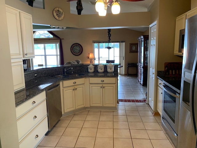 1585 Stefan Cole Ln, Apopka, FL 32703 - kitchen featuring stainless steel appliances, a sink, a peninsula, a chandelier, and plenty of natural light