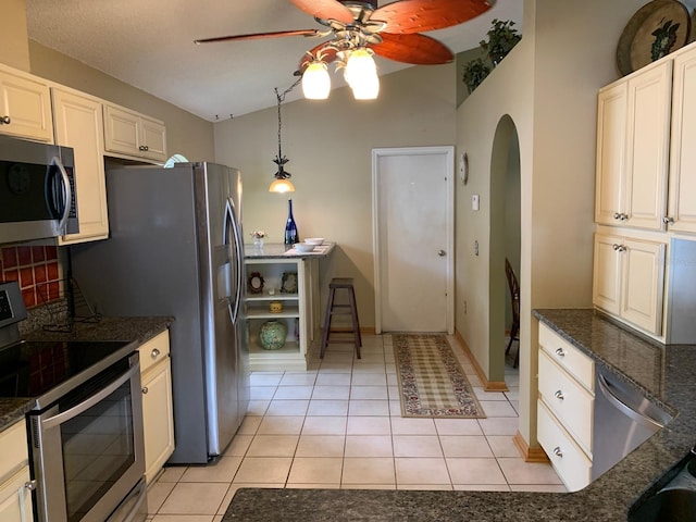 1585 Stefan Cole Ln, Apopka, FL 32703 - kitchen featuring stainless steel appliances, arched walkways, a ceiling fan, lofted ceiling, and light tile patterned floors