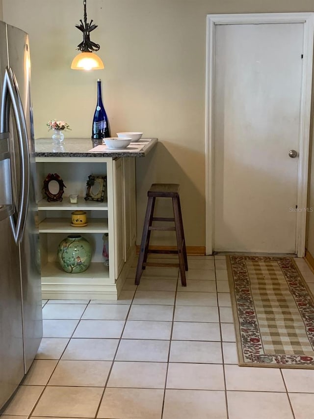 1585 Stefan Cole Ln, Apopka, FL 32703 - kitchen with stainless steel fridge, light tile patterned floors, and baseboards