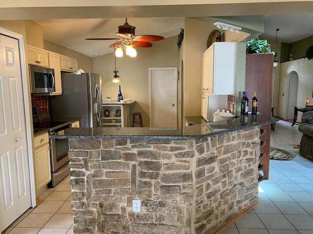 1585 Stefan Cole Ln, Apopka, FL 32703 - kitchen with appliances with stainless steel finishes, light tile patterned floors, ceiling fan, and arched walkways