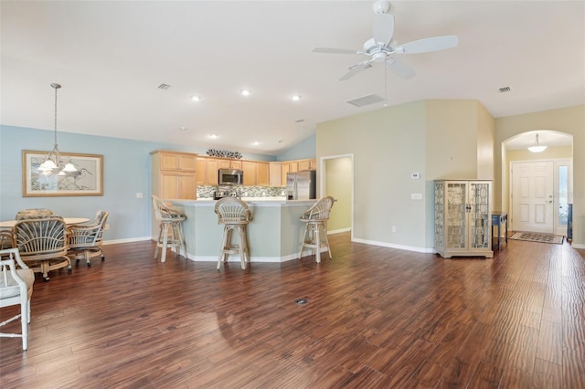 living area featuring arched walkways, lofted ceiling, ceiling fan, dark wood-style flooring, and baseboards