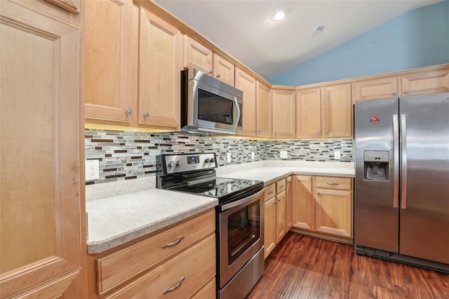 kitchen featuring stainless steel appliances, light brown cabinetry, vaulted ceiling, backsplash, and recessed lighting