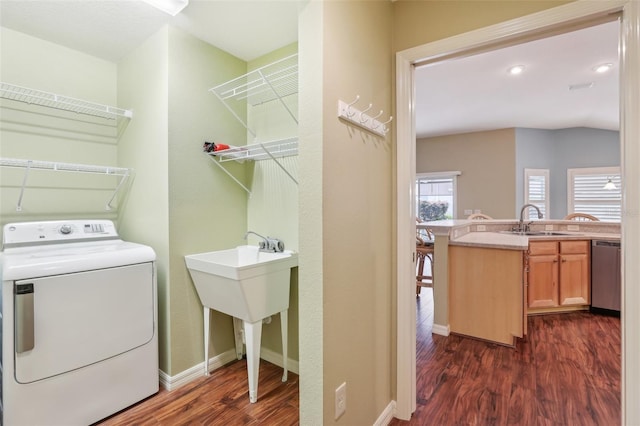 washroom featuring washer / dryer, dark wood finished floors, and baseboards