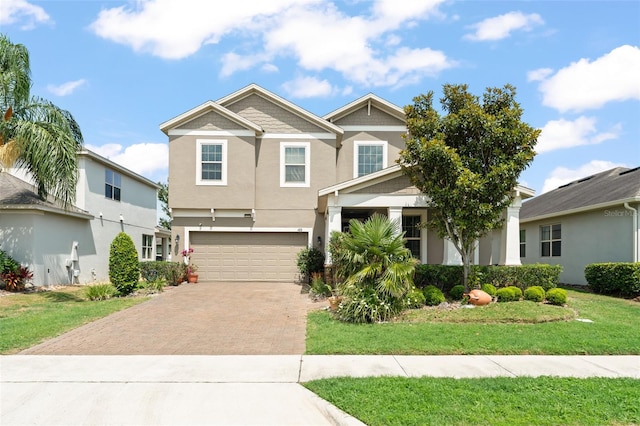 488 Kistler Cir, Clermont, FL 34715 - view of front facade with decorative driveway, an attached garage, a front lawn, and stucco siding
