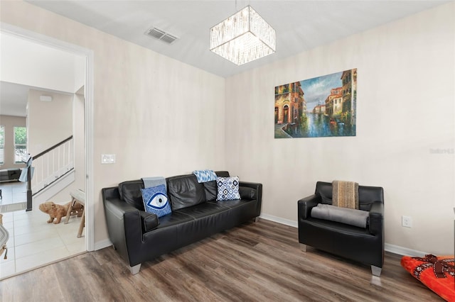 488 Kistler Cir, Clermont, FL 34715 - living area with wood finished floors, a chandelier, stairs, and baseboards