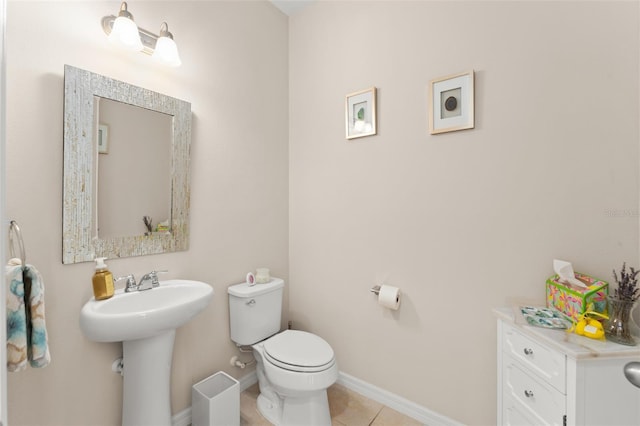 488 Kistler Cir, Clermont, FL 34715 - half bath with tile patterned floors, toilet, baseboards, and a sink