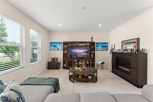 488 Kistler Cir, Clermont, FL 34715 - living room with light tile patterned floors, recessed lighting, baseboards, and a glass covered fireplace
