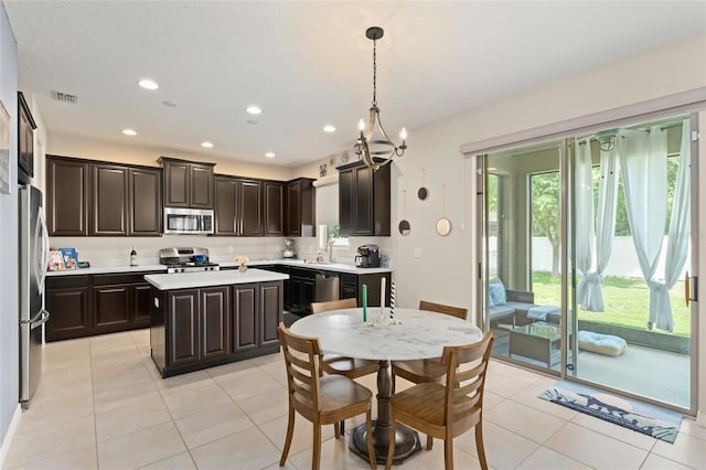 488 Kistler Cir, Clermont, FL 34715 - kitchen featuring appliances with stainless steel finishes, light countertops, a sink, dark brown cabinets, and recessed lighting