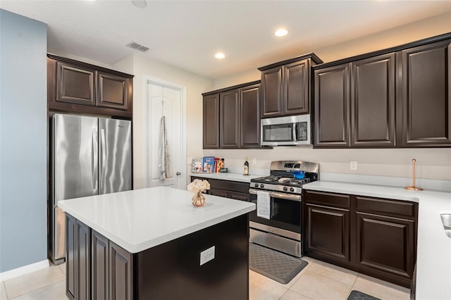 488 Kistler Cir, Clermont, FL 34715 - kitchen featuring stainless steel appliances, light tile patterned flooring, light countertops, a kitchen island, and recessed lighting