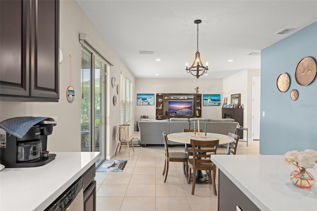 488 Kistler Cir, Clermont, FL 34715 - kitchen with light countertops, light tile patterned flooring, a chandelier, decorative light fixtures, and open floor plan