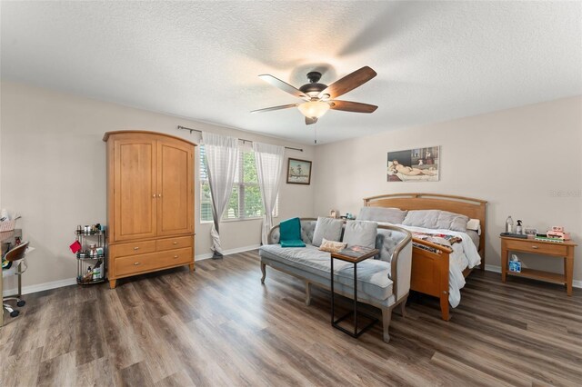 488 Kistler Cir, Clermont, FL 34715 - bedroom featuring wood finished floors, a textured ceiling, baseboards, and a ceiling fan