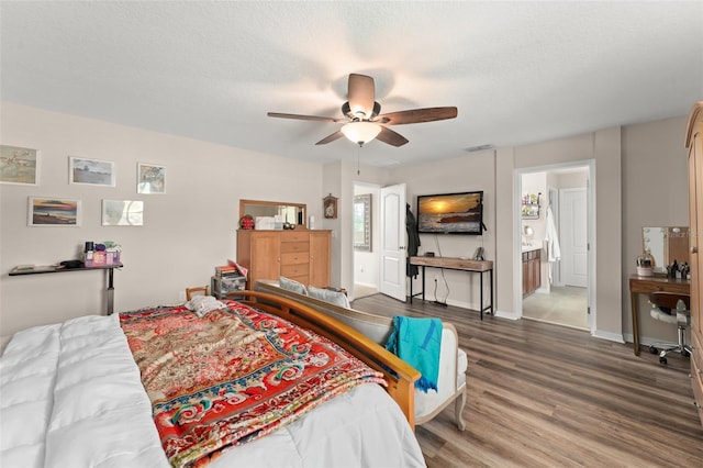 488 Kistler Cir, Clermont, FL 34715 - bedroom with wood finished floors, ensuite bathroom, baseboards, and a ceiling fan