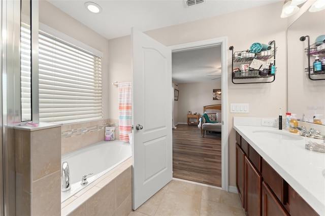 488 Kistler Cir, Clermont, FL 34715 - full bathroom with a bath, double vanity, ensuite bathroom, and tile patterned floors