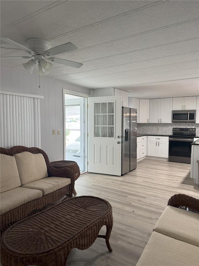 2116 Wax Myrtle Dr Unit Ge, Zellwood, FL 32798 - living area with light wood-style flooring and a ceiling fan