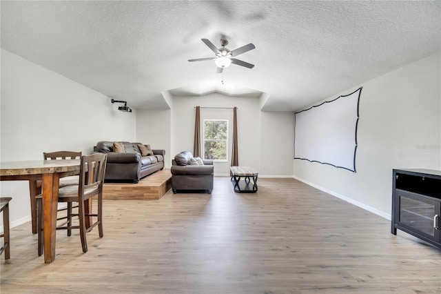 3380 Pawleys Loop N, Saint Cloud, FL 34769 - home theater featuring a ceiling fan, wood finished floors, a textured ceiling, and baseboards