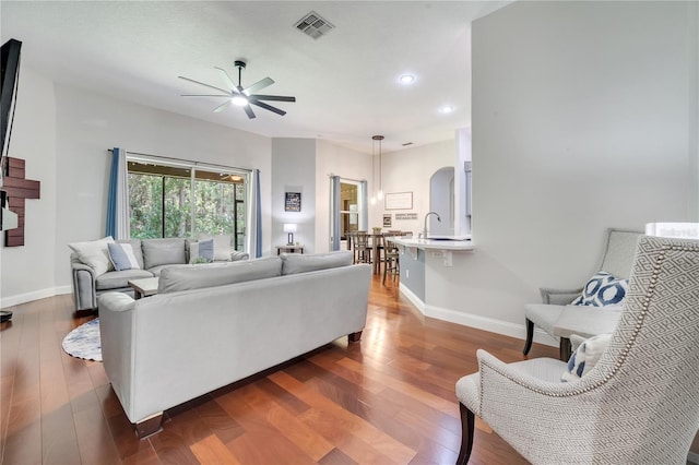 3380 Pawleys Loop N, Saint Cloud, FL 34769 - living area with ceiling fan, baseboards, dark wood-style flooring, recessed lighting, and arched walkways