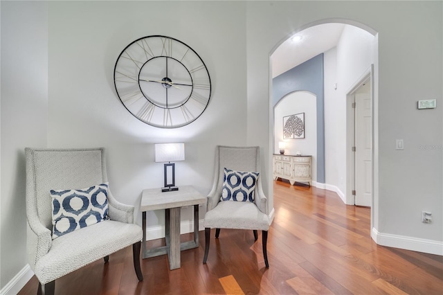 3380 Pawleys Loop N, Saint Cloud, FL 34769 - sitting room with wood finished floors, arched walkways, and baseboards