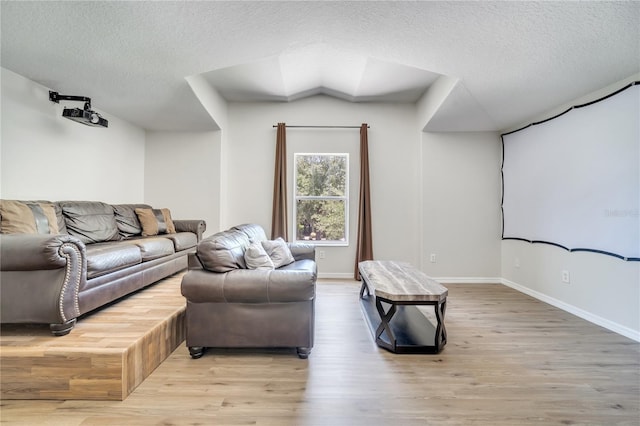 3380 Pawleys Loop N, Saint Cloud, FL 34769 - cinema room featuring a textured ceiling, light wood-style flooring, and baseboards