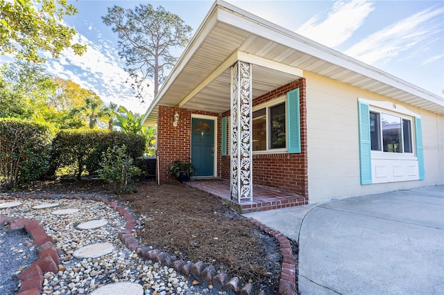 2001 Lily Ct, Sanford, FL 32771 - doorway to property featuring covered porch and brick siding