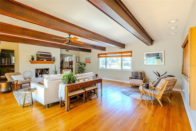 2001 Lily Ct, Sanford, FL 32771 - living area featuring baseboards, light wood-style flooring, a fireplace, a ceiling fan, and beam ceiling