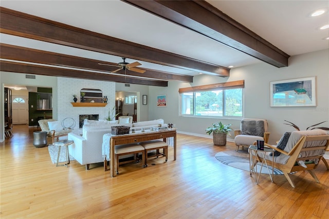 2001 Lily Ct, Sanford, FL 32771 - living area featuring light wood-type flooring, baseboards, ceiling fan, beam ceiling, and a fireplace