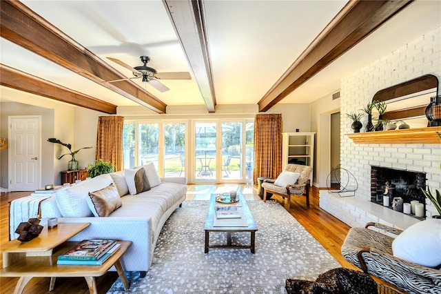 2001 Lily Ct, Sanford, FL 32771 - living area with wood finished floors, ceiling fan, a brick fireplace, and beam ceiling