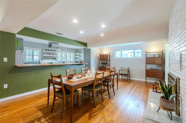 2001 Lily Ct, Sanford, FL 32771 - dining space with hardwood / wood-style floors, baseboards, recessed lighting, and a fireplace