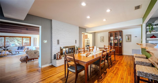 2001 Lily Ct, Sanford, FL 32771 - dining area with a fireplace, light wood-type flooring, recessed lighting, and baseboards