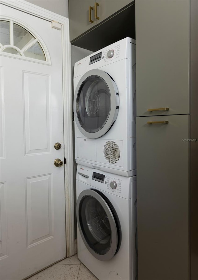 2001 Lily Ct, Sanford, FL 32771 - laundry area with stacked washer and clothes dryer and light tile patterned floors