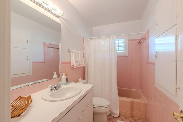 2001 Lily Ct, Sanford, FL 32771 - full bath with tile walls, toilet, vanity, shower / bathtub combination with curtain, and a wainscoted wall