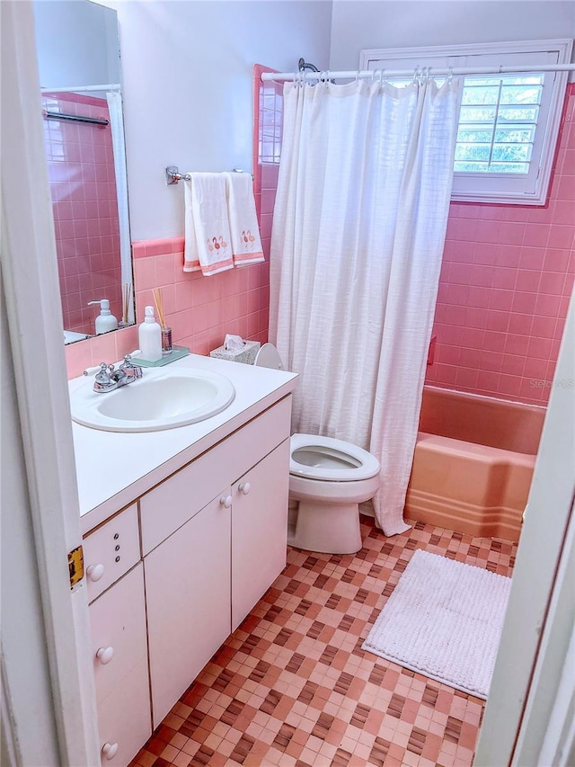 2001 Lily Ct, Sanford, FL 32771 - bathroom with tile patterned floors, tile walls, toilet, shower / tub combo with curtain, and vanity