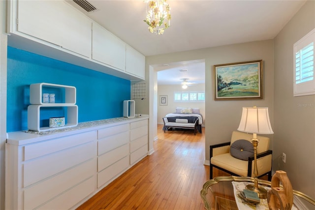 2001 Lily Ct, Sanford, FL 32771 - bedroom with multiple windows, light wood finished floors, and a chandelier