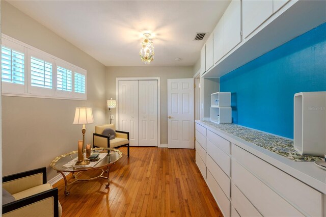 2001 Lily Ct, Sanford, FL 32771 - sitting room with a chandelier, light wood-style floors, and baseboards
